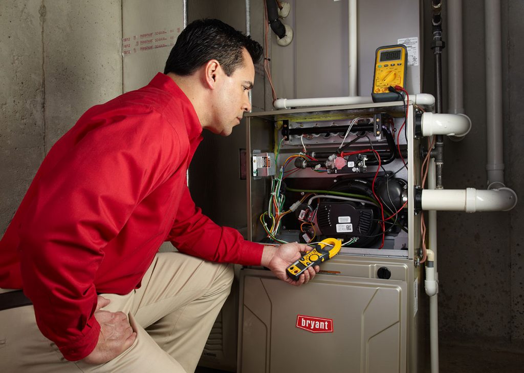 HVAC technician repairing an indoor furnace in Saratoga Springs