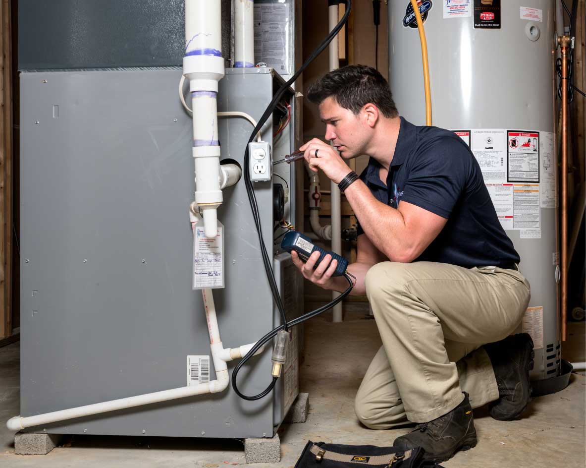 HVAC technician performing a furnace tune-up in Saratoga Springs