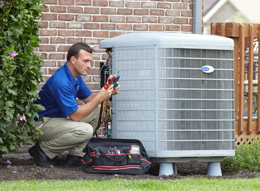 HVAC technician inspecting an outdoor air conditioning unit in Saratoga Springs