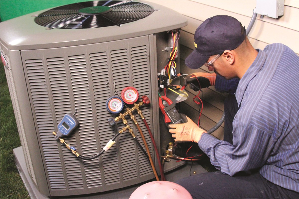 HVAC technician testing an outdoor air conditioning unit in Saratoga Springs